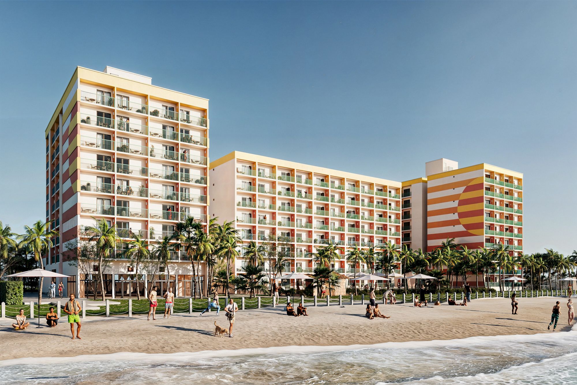 A beachfront hotel with colorful balconies, surrounded by palm trees and beachgoers enjoying the sunny day at the shore.